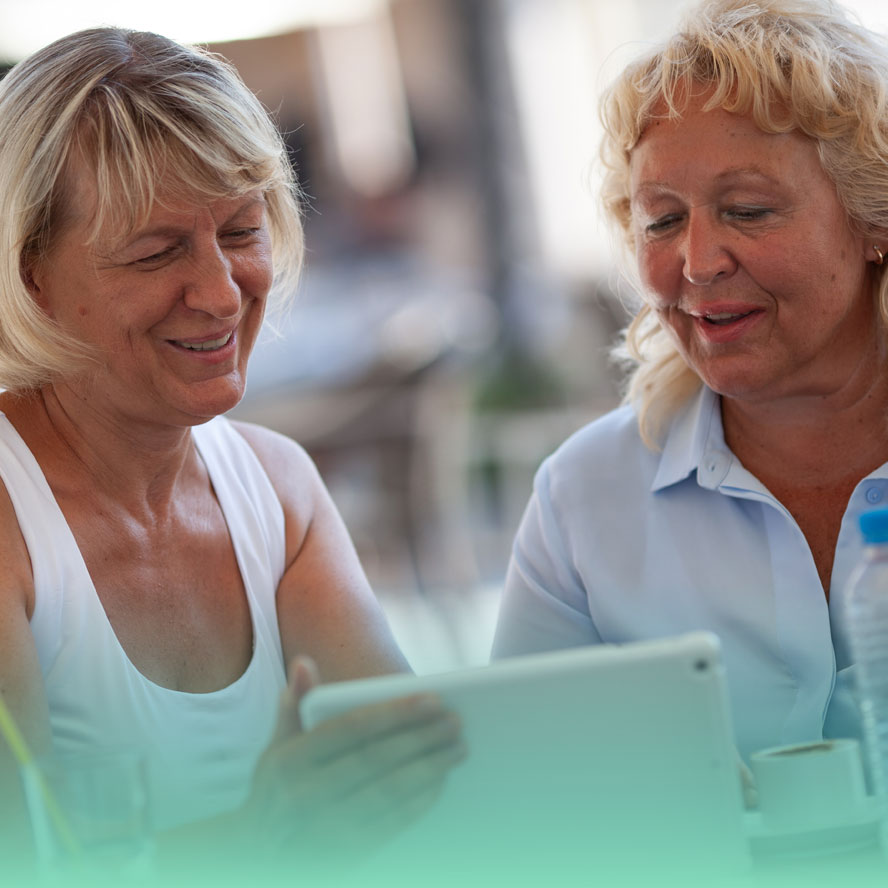Two smiling women eating lunch